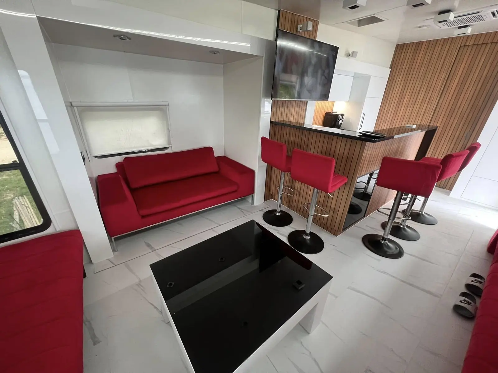 Caravan interior with red sofas built by Meble z Pomysłem