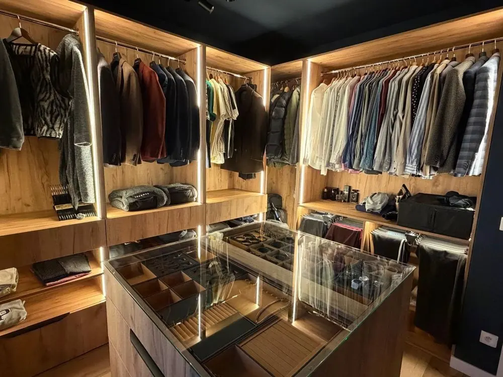 Walk-in closet with illuminated shelves